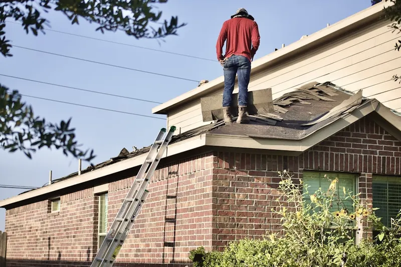 Professional roofer working on a residential roof in Old Town Meridian